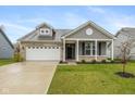 Charming single-Gathering home with a brick and gray facade, attached two-car garage, and a well-maintained lawn at 1468 Lexington Trl, Greenfield, IN 46140