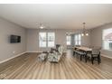 Open-concept living room featuring wood floors, recessed lighting, and seating area with decorative patterned chair at 1468 Lexington Trl, Greenfield, IN 46140