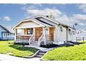 Charming single-story home featuring a wood porch, new landscaping, and beautiful curb appeal at 1511 E Tabor St, Indianapolis, IN 46203