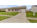 This charming home is complemented by a spacious concrete driveway, offering plenty of parking space at 1517 Citation N Cir, Lebanon, IN 46052