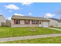 Cozy single-Gathering home with red shutters, a well-manicured lawn, and an attached one-car garage at 1517 Citation N Cir, Lebanon, IN 46052