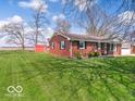 Single-story brick home with a spacious backyard and a storage shed, perfect for outdoor enjoyment and storage at 1734 Bittersweet Dr, Anderson, IN 46011