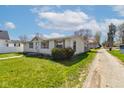 Inviting single-story home with fresh green lawn, classic curb appeal, and a gravel driveway at 220 E Meridian St, Atlanta, IN 46031