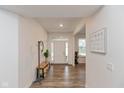 Bright hallway features wood floors, bench, coat rack, and white trim at 2208 Dudley Ave, Westfield, IN 46074