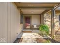 Covered front porch with a seating bench and a 'Come In' mat, perfect for relaxing outdoors at 2214 Van Ness Pl, Indianapolis, IN 46240