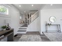 Open-concept entryway with a staircase, wood floors, and decorative details at 2226 N Capitol Ave, Indianapolis, IN 46208