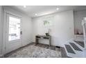 Bright foyer featuring modern lighting, wood floors, and a staircase at 2226 N Capitol Ave, Indianapolis, IN 46208