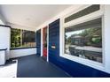 Charming porch with blue walls, a red door, and views of the landscaped yard at 2226 N Capitol Ave, Indianapolis, IN 46208