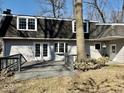 The backyard has a deck and is surrounded by mature trees providing ample shade at 2605 W Berkshire Dr, Muncie, IN 47304