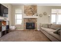 Cozy living room featuring a stone fireplace, neutral paint, and plush carpet at 3510 Oak Tree Cir, Indianapolis, IN 46227
