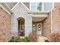 Inviting front porch with stone accents, decorative wreath, and a cozy seating area at 3665 Conifer Dr, Zionsville, IN 46077