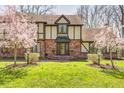 Inviting brick home with a covered entryway, complemented by well-maintained landscaping and decorative lighting at 3753 Whippoorwill Lake S Dr, Monrovia, IN 46157