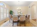 Formal dining room with a large window, decorative rug and classic chandelier at 442 Athens Pl, Westfield, IN 46074