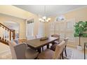 Dining room with elegant furniture, arched doorway, and ample natural light from large window at 442 Athens Pl, Westfield, IN 46074