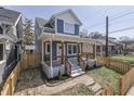 Beautiful home showcasing a classic design, inviting front porch, and a well-maintained lawn at 451 N Gray St, Indianapolis, IN 46201