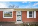Close up of the front door and window of this brick house at 4829 W 37Th St, Indianapolis, IN 46224