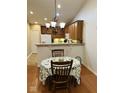 Cozy dining area with a chandelier adjacent to the kitchen at 4871 Franklin Villas Dr, Indianapolis, IN 46237