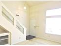 Bright living room featuring a staircase with glass accents, neutral paint, and plush carpeting at 4959 Clarkson Dr, Indianapolis, IN 46254