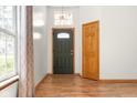 Bright foyer with wood floors, an elegant front door, and sidelight, offering a warm welcome at 5105 Hawks Crescent Ct, Indianapolis, IN 46254