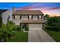 Charming two-story home featuring a two-car garage and a well-manicured lawn at 518 Carthage Cir, Westfield, IN 46074