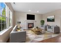 Cozy living room features a fireplace, neutral tones, and a large window providing natural light at 518 Carthage Cir, Westfield, IN 46074