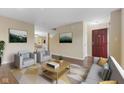 Inviting living room featuring neutral tones, comfortable seating, and seamless access to other living spaces at 518 Carthage Cir, Westfield, IN 46074