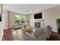 Comfortable living room with fireplace, complemented by neutral colors and ample natural light from the large window at 518 Carthage Cir, Westfield, IN 46074