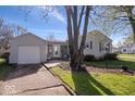 This home has a spacious backyard and includes a detached garage and a quaint patio area for relaxing at 5277 Kingsley Dr, Indianapolis, IN 46220