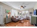 Inviting living room featuring hardwood floors, a ceiling fan, lots of light, and modern decor and furnishings at 5277 Kingsley Dr, Indianapolis, IN 46220