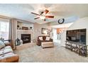 Inviting living room with fireplace, ceiling fan, and plush carpeting at 591 Scotch Pine Dr, Greenwood, IN 46143