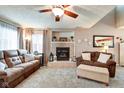 Cozy living room featuring a fireplace, soft lighting, and ample seating at 591 Scotch Pine Dr, Greenwood, IN 46143