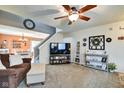 Comfortable living area with neutral carpeting, ceiling fan, and staircase at 591 Scotch Pine Dr, Greenwood, IN 46143