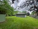 Lush backyard with a shed, showcasing the expansive green space, perfect for outdoor enjoyment and storage at 605 Queenswood Dr, Indianapolis, IN 46217