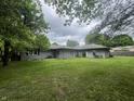 Spacious backyard featuring a well-maintained lawn, ideal for outdoor activities and relaxation at 605 Queenswood Dr, Indianapolis, IN 46217
