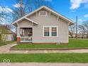 Charming single-story home with well-manicured lawn and inviting front porch at 614 Elm St, Shelbyville, IN 46176
