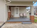 Inviting front porch with seating and a 'Welcome' mat, perfect for relaxing at 614 Elm St, Shelbyville, IN 46176
