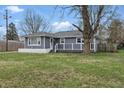 Charming single-story home with gray siding, white brick foundation and a well-maintained front lawn at 6303 Bertha St, Indianapolis, IN 46241