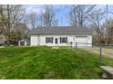 The backyard features a well-maintained lawn, a shed, and a chain-link fence at 7145 Lafayette Rd, Indianapolis, IN 46278