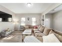 Spacious living room featuring stylish flooring, neutral walls and a comfortable, oversized sectional sofa at 106 N Linwood Ave, Indianapolis, IN 46201