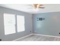 Bright bedroom with gray walls, ceiling fan, and wall-mounted TV bracket at 1139 Topp Creek Dr, Indianapolis, IN 46214