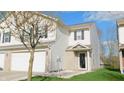Charming townhome showcasing neutral siding, dark shutters, and an attached garage at 1139 Topp Creek Dr, Indianapolis, IN 46214