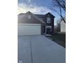 Well-maintained two-story brick home with a two car garage, showcasing its inviting facade at 13660 N Ayrshire Cir, Camby, IN 46113