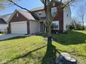 Lovely two-story home with brick and siding, featuring a well-kept lawn and mature tree at 13660 N Ayrshire Cir, Camby, IN 46113