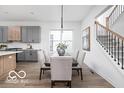 Bright open-concept dining area with white walls and view of the staircase at 17354 Ditch Rd, Westfield, IN 46074