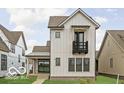 Striking two-story home with white siding, black trim, and a cute balcony at 17354 Ditch Rd, Westfield, IN 46074