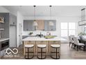 Modern kitchen with an island, a breakfast bar and stylish gray cabinets at 17354 Ditch Rd, Westfield, IN 46074
