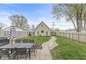 Spacious backyard featuring a dining table, an outdoor structure, and a stone walkway at 1741 Caldwell Pl, Columbus, IN 47201
