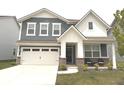 Charming two-story home with blue and white siding, a well-manicured lawn, and a two car garage at 2250 Egbert Rd, Westfield, IN 46074