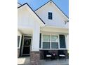 Charming two-story home featuring a welcoming porch with stylish brickwork and an inviting front door with a wreath at 2250 Egbert Rd, Westfield, IN 46074