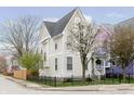 Charming two-story home with flowering tree in the front yard, black metal fence at 2263 N Delaware St, Indianapolis, IN 46205